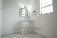 同仕様写真。三面鏡つき洗面台。収納も一体型になっているので、ドライヤーやヘアアイロンの置き場に困りませんね。