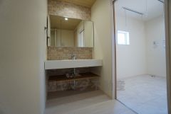 同仕様写真。三面鏡つき洗面台。収納も一体型になっているので、ドライヤーやヘアアイロンの置き場に困りませんね。