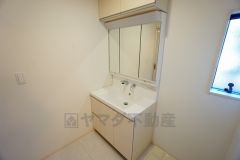 同仕様写真。三面鏡つき洗面台。鏡裏にたっぷりとした収納スペースがあります。鏡を閉めてしまえば小物は見えないため、スッキリとした印象の洗面台にできます。