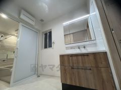 三面鏡つき洗面台。収納も一体型になっているので、ドライヤーやヘアアイロンの置き場に困りませんね。